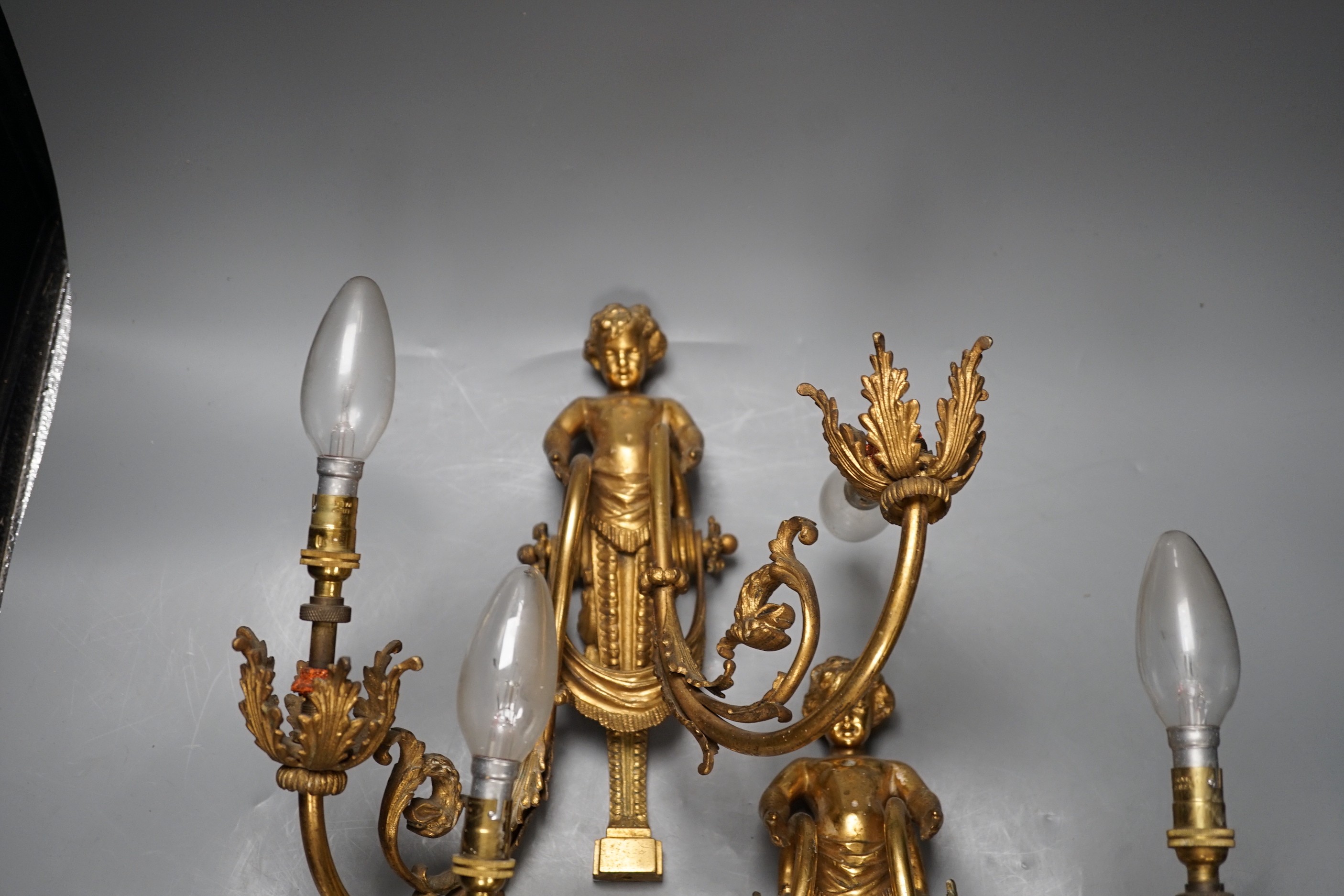 A pair of Louis XVI style ormolu figural twin branch wall lights, 30cm high